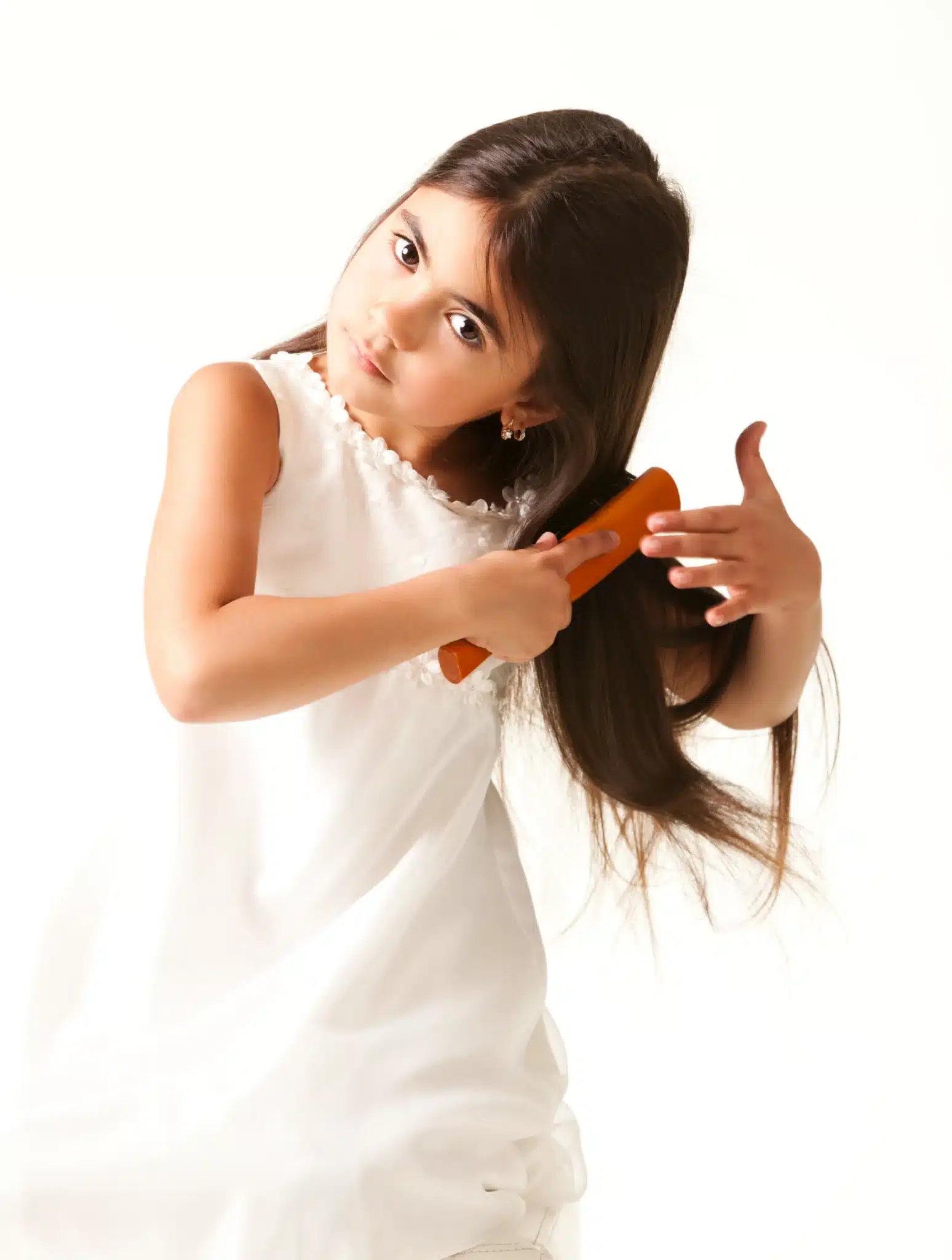 Colorado Springs girl in white dress combing brown hair scaled
